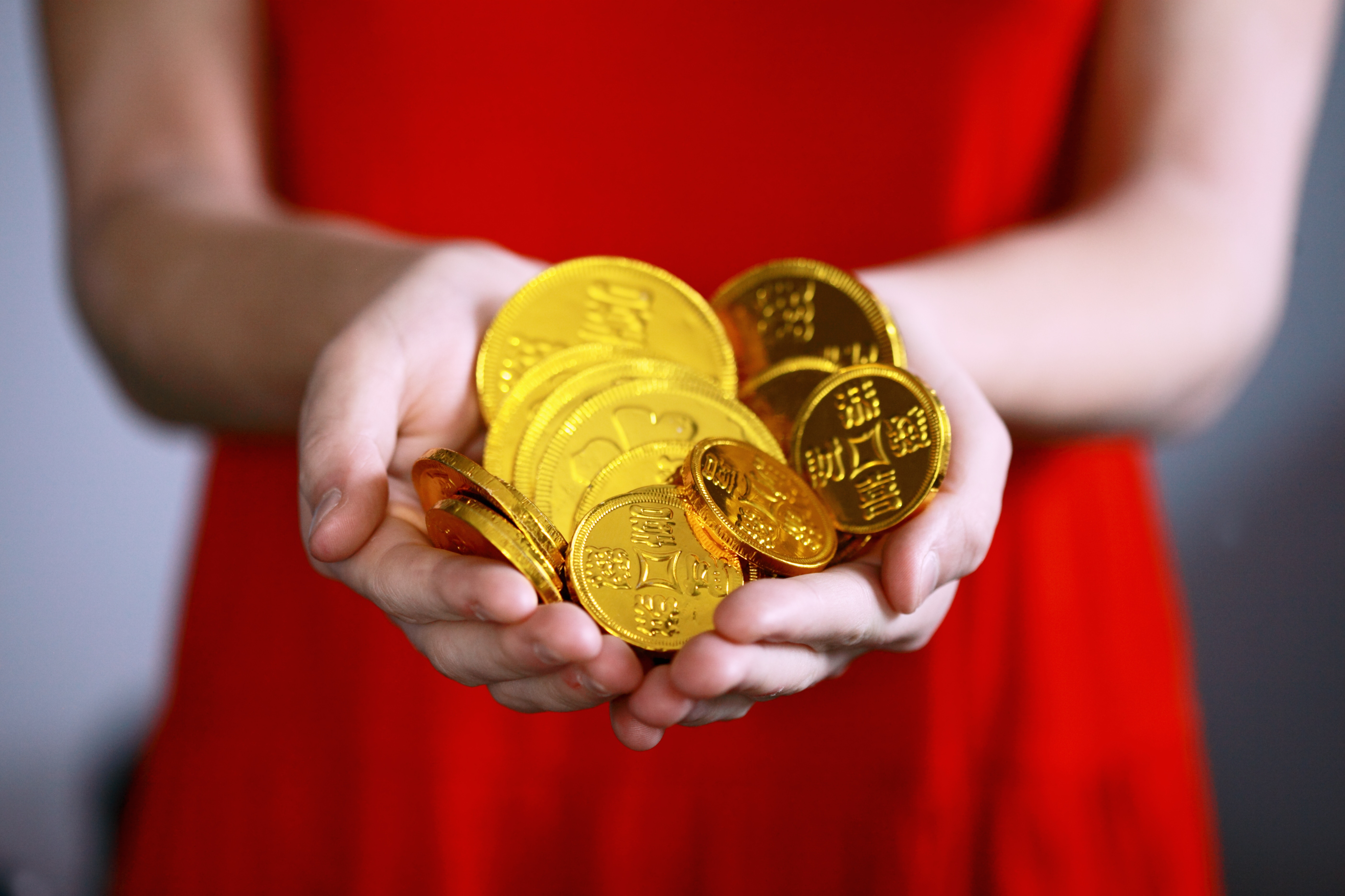 Woman holding gold coins