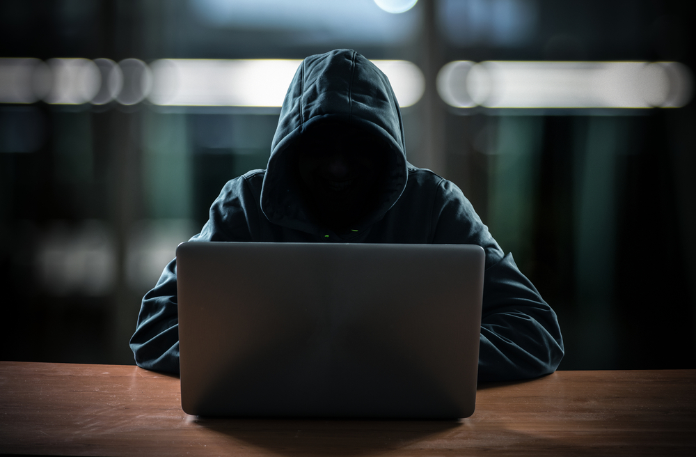 hacker-in-front-of-laptop-wearing-sweatshirt