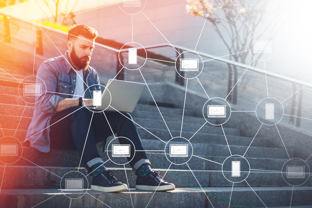 man-sitting-on-steps-with-laptop-blockchain